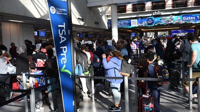 People are seen in a TSA security checkpoint line at Orlando 